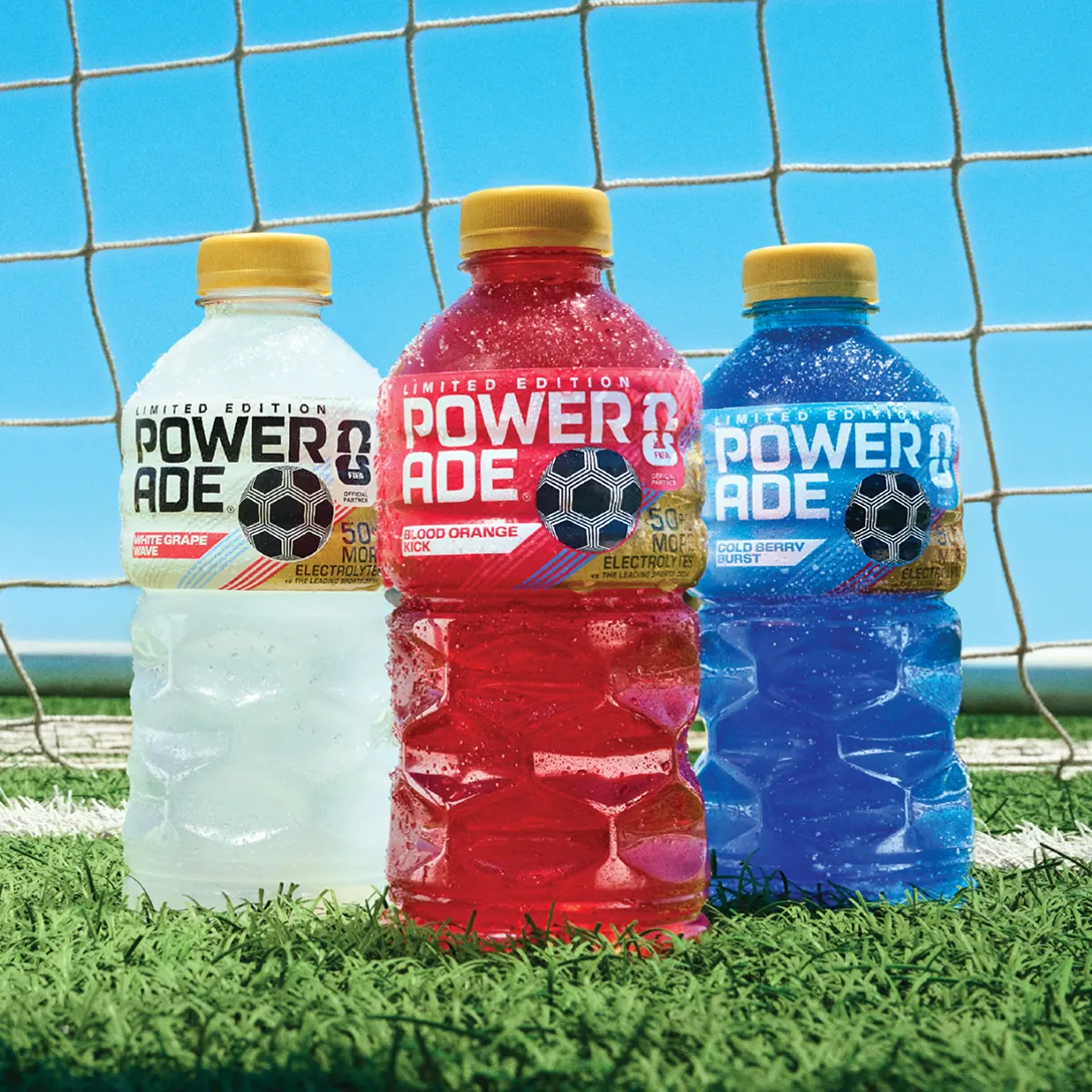 Three bottles of Powerade Legacy Lineup Drinks on a soccer field